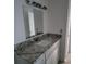 Bathroom vanity with a marble countertop, ample storage and a large mirror at 1055 S Hiawassee Rd # 2027, Orlando, FL 32835