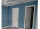 Bedroom featuring a ceiling fan, light grey flooring, and doors to bathroom and closet at 1055 S Hiawassee Rd # 2027, Orlando, FL 32835