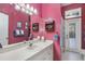 Pink bathroom featuring a large mirror, vanity, and a shower with a patterned curtain at 107 Springhurst Cir, Lake Mary, FL 32746