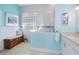 Coastal bathroom featuring a glass-enclosed shower, blue accents, and a decorative bench at 107 Springhurst Cir, Lake Mary, FL 32746