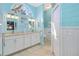 Bright bathroom with double vanity, blue walls, shiplap, and a toilet behind a closed door at 107 Springhurst Cir, Lake Mary, FL 32746