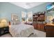 Cozy bedroom with floral bedding, a ceiling fan, and natural light from the windows at 107 Springhurst Cir, Lake Mary, FL 32746