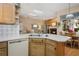 Open-concept kitchen featuring a dishwasher, double basin sink, breakfast nook and a pass through to the living room at 107 Springhurst Cir, Lake Mary, FL 32746