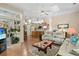 Open-concept living room featuring hardwood floors, skylight, and a seamless transition to the dining and kitchen areas at 107 Springhurst Cir, Lake Mary, FL 32746