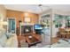 Cozy living room with hardwood floors, fireplace, and sliding glass doors that offer a serene pool view at 107 Springhurst Cir, Lake Mary, FL 32746