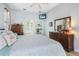 Comfortable main bedroom with dressers, a ceiling fan, a TV, and an attached bathroom at 107 Springhurst Cir, Lake Mary, FL 32746