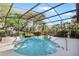 Beautiful screened-in pool with a hot tub surrounded by lush landscaping and greenery at 107 Springhurst Cir, Lake Mary, FL 32746