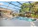 A screened-in pool with a spa and lounge area, perfect for relaxing and entertaining at 107 Springhurst Cir, Lake Mary, FL 32746