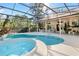 Backyard screened pool and spa provides a relaxing outdoor living space for enjoying the Florida sunshine at 107 Springhurst Cir, Lake Mary, FL 32746