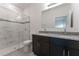 Bathroom featuring marble-tiled shower with glass door, dual granite vanity, and modern fixtures at 13220 Sw 85Th Cir, Ocala, FL 34473