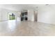 Bright, open living space showcasing tile floors, and a modern kitchen with backyard access at 13220 Sw 85Th Pl, Ocala, FL 34473