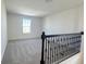 Upstairs bonus room featuring neutral carpet, natural light, and a view of the neighborhood at 14575 Crestavista Ave, Clermont, FL 34714