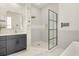 Luxurious bathroom featuring marble walls, a glass shower, and modern vanity with gold fixtures at 1531 Lake Baldwin Ln, Orlando, FL 32814