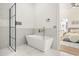 Modern bathroom showcasing a soaking tub, a glass shower, and a view into the bedroom at 1531 Lake Baldwin Ln, Orlando, FL 32814