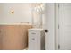 A half bathroom with a vessel sink, gold fixtures and wood-paneled accent wall at 1531 Lake Baldwin Ln, Orlando, FL 32814