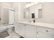 Bathroom featuring a shower and vanity with white cabinets and large mirror at 1531 Lake Baldwin Ln, Orlando, FL 32814