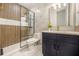 Modern bathroom features wood-look tile, marble accent wall, and sleek vanity at 1531 Lake Baldwin Ln, Orlando, FL 32814