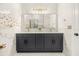 Modern bathroom featuring a double vanity, sleek black cabinets, and luxurious marble countertops and walls at 1531 Lake Baldwin Ln, Orlando, FL 32814