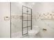 Stylish bathroom showcasing a glass-enclosed shower with black trim, a toilet, and elegant marble accents at 1531 Lake Baldwin Ln, Orlando, FL 32814