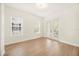 Bedroom featuring light walls, hardwood floors, windows, and a door leading to a balcony at 1531 Lake Baldwin Ln, Orlando, FL 32814