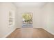 Bedroom with light walls, hardwood floors, windows, and a door leading to a balcony at 1531 Lake Baldwin Ln, Orlando, FL 32814