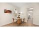 Dining area with a small table and wicker chairs illuminated by a window at 1531 Lake Baldwin Ln, Orlando, FL 32814