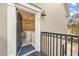 View of the home's entryway with a black door, black railing, and an elegant chandelier visible inside at 1531 Lake Baldwin Ln, Orlando, FL 32814