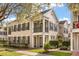 Elegant townhome exterior featuring black shutters, landscaping, and a well-manicured green lawn at 1531 Lake Baldwin Ln, Orlando, FL 32814