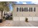 Exterior view of townhomes with white garage doors and windows with black shutters at 1531 Lake Baldwin Ln, Orlando, FL 32814