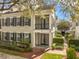 Beautiful townhome with a brick walkway, lush landscaping, and a covered front porch and balcony at 1531 Lake Baldwin Ln, Orlando, FL 32814