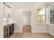 Hallway area with a wine fridge, white cabinets, hardwood floors, and natural light from a nearby window at 1531 Lake Baldwin Ln, Orlando, FL 32814