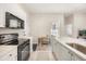 Modern kitchen with white cabinets, black appliances, and a cozy breakfast nook with natural light at 1531 Lake Baldwin Ln, Orlando, FL 32814