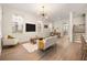 Bright living room featuring hardwood floors, white walls, and an elegant light fixture at 1531 Lake Baldwin Ln, Orlando, FL 32814