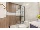 Modern shower with glass door features wood-look accent wall and sleek fixtures at 1531 Lake Baldwin Ln, Orlando, FL 32814