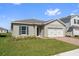 Single-story home boasting a well-manicured lawn and brick driveway at 1630 Laia Rd, Haines City, FL 33844