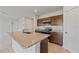 Kitchen island featuring a sink, granite countertops, and stainless steel appliances at 1630 Laia Rd, Haines City, FL 33844