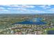 Stunning aerial view of a lakeside community with lush greenery and beautiful homes under a bright blue sky at 1657 Cherry Ridge Dr, Lake Mary, FL 32746