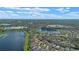 Picturesque aerial view of lakeside homes surrounded by lush greenery, creating a serene and inviting neighborhood at 1657 Cherry Ridge Dr, Lake Mary, FL 32746