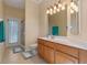 Well-lit bathroom features wood vanity with double light fixture and mirror and a tiled floor at 1657 Cherry Ridge Dr, Lake Mary, FL 32746