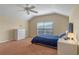 Comfortable bedroom with neutral tones, a vaulted ceiling, plush carpeting, and a window for natural light at 1657 Cherry Ridge Dr, Lake Mary, FL 32746