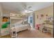 Well-lit bedroom featuring a bunk bed, a desk, and neutral carpet at 1657 Cherry Ridge Dr, Lake Mary, FL 32746