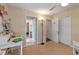 Bright bedroom featuring neutral carpet, a desk, and access to ensuite bathroom and closet at 1657 Cherry Ridge Dr, Lake Mary, FL 32746