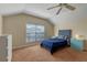 Cozy bedroom with a vaulted ceiling, a plush bed, and a large window allowing for natural light at 1657 Cherry Ridge Dr, Lake Mary, FL 32746