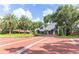 Inviting brick-paved community entrance with stately gatehouse and beautifully landscaped surroundings at 1657 Cherry Ridge Dr, Lake Mary, FL 32746