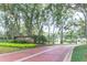 Charming community entrance featuring a brick-paved road, lush greenery, and an elegant, welcoming sign at 1657 Cherry Ridge Dr, Lake Mary, FL 32746