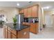 Well-equipped kitchen island with granite countertops, stainless steel appliances, and natural wood cabinetry at 1657 Cherry Ridge Dr, Lake Mary, FL 32746