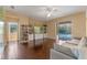 Beautiful living room with hardwood floors, a TV, built-in bookshelves, and a sliding glass door to the pool at 1657 Cherry Ridge Dr, Lake Mary, FL 32746