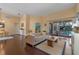 Bright living room featuring hardwood floors, stylish furniture, and sliding doors to the outdoor pool area at 1657 Cherry Ridge Dr, Lake Mary, FL 32746