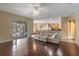 Open-concept living room with hardwood floors seamlessly connects to the kitchen and features a sliding door to the patio at 1657 Cherry Ridge Dr, Lake Mary, FL 32746