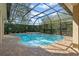 A gorgeous screened-in pool area featuring a waterfall feature and plenty of privacy at 1657 Cherry Ridge Dr, Lake Mary, FL 32746